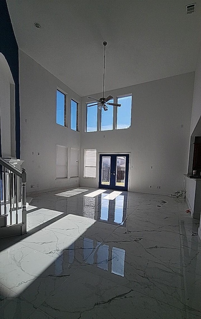 living room featuring french doors and ceiling fan