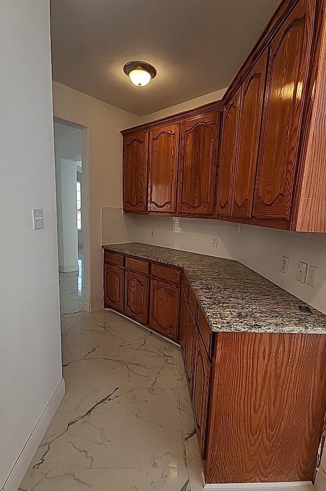 kitchen featuring dark stone counters and a textured ceiling