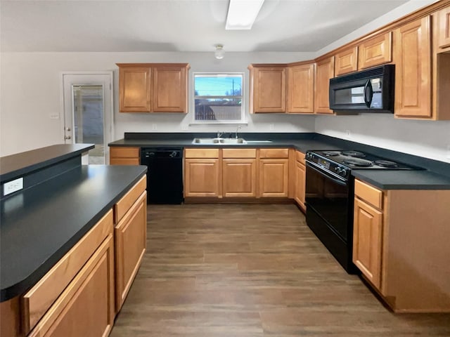 kitchen with dark hardwood / wood-style flooring, sink, and black appliances