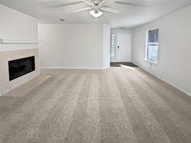 unfurnished living room with ceiling fan and carpet