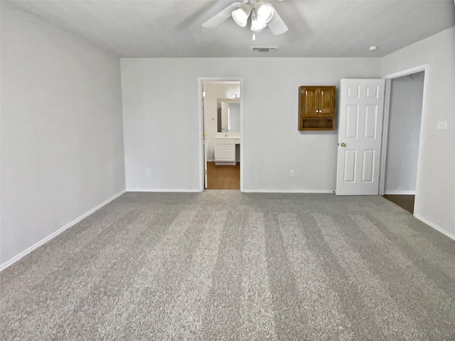 unfurnished room featuring dark colored carpet and ceiling fan