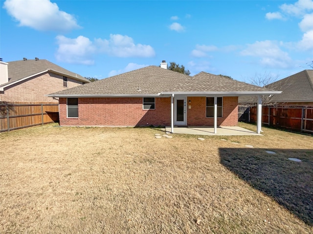 back of house featuring a lawn and a patio area