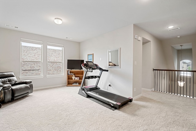 exercise area with carpet, visible vents, and baseboards