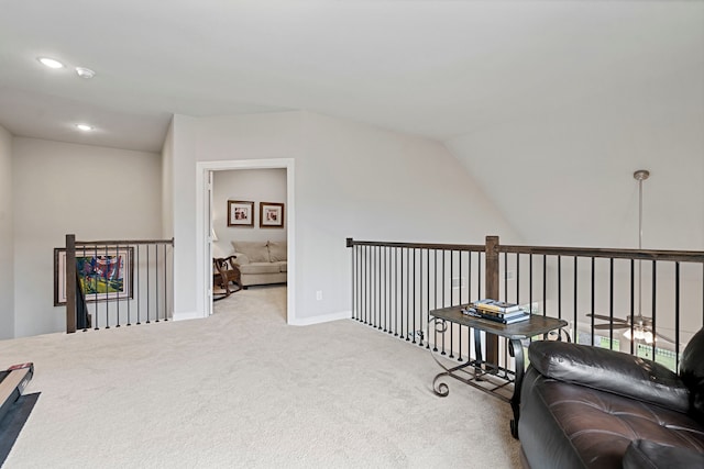 sitting room featuring lofted ceiling, recessed lighting, carpet flooring, an upstairs landing, and baseboards