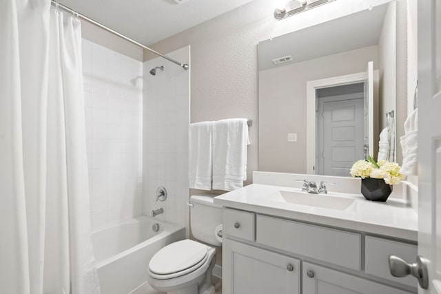 bathroom with visible vents, a textured wall, toilet, shower / bath combination with curtain, and vanity