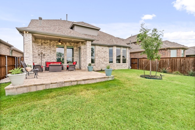 back of house featuring outdoor lounge area, a lawn, a ceiling fan, a patio area, and a fenced backyard