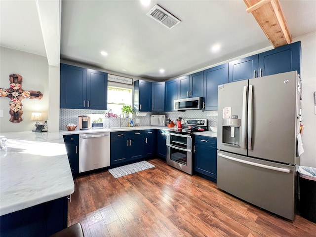 kitchen with stainless steel appliances, dark hardwood / wood-style flooring, blue cabinets, and sink