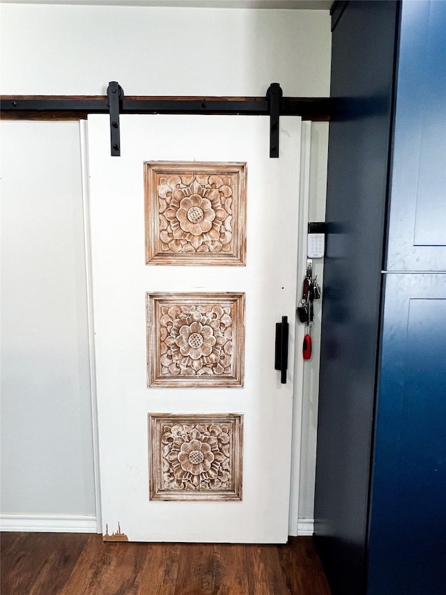 details with wood-type flooring and a barn door