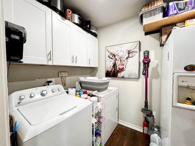 clothes washing area featuring cabinets, dark hardwood / wood-style flooring, and washing machine and dryer