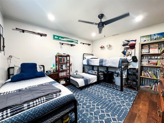 bedroom with dark hardwood / wood-style flooring and ceiling fan