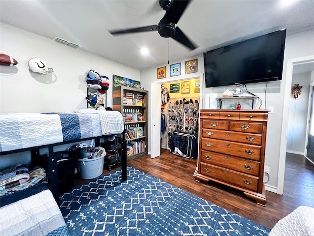 bedroom with dark hardwood / wood-style floors and ceiling fan