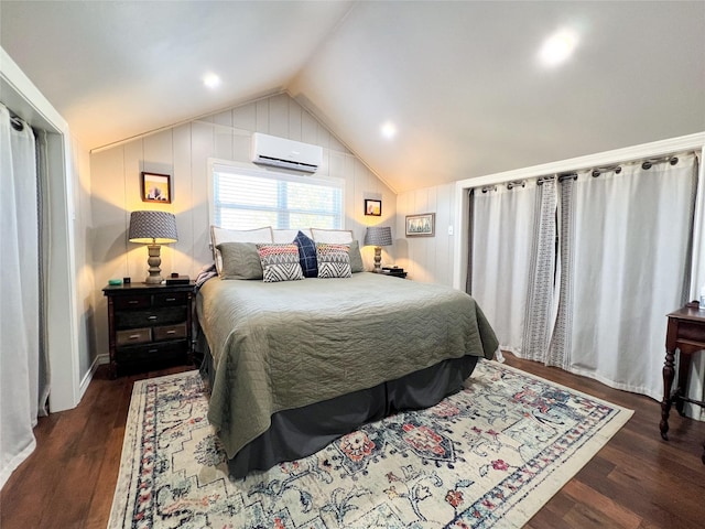 bedroom featuring dark wood-type flooring, vaulted ceiling, and a wall mounted AC