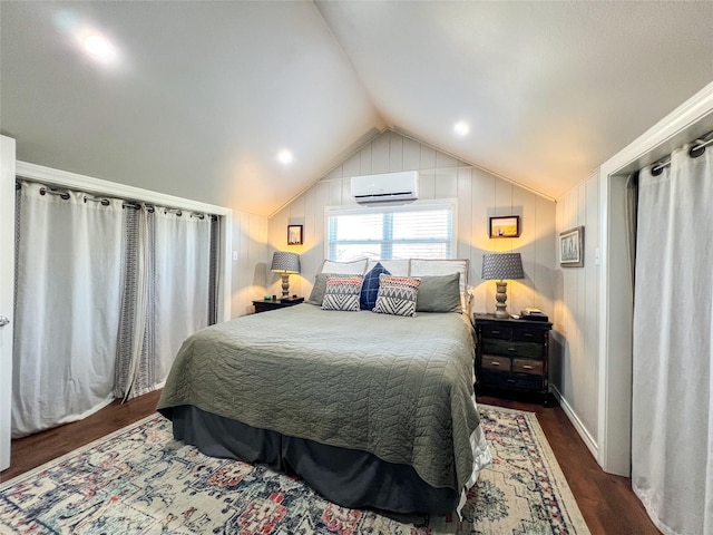 bedroom featuring dark hardwood / wood-style flooring, a wall mounted air conditioner, and vaulted ceiling