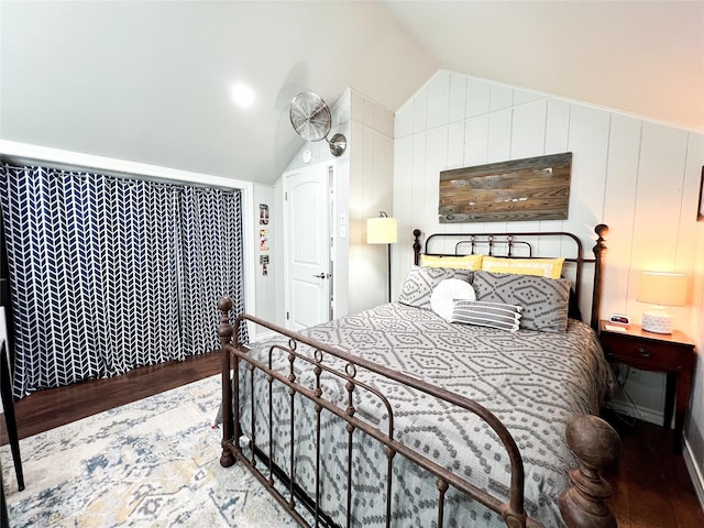 bedroom featuring hardwood / wood-style flooring and vaulted ceiling