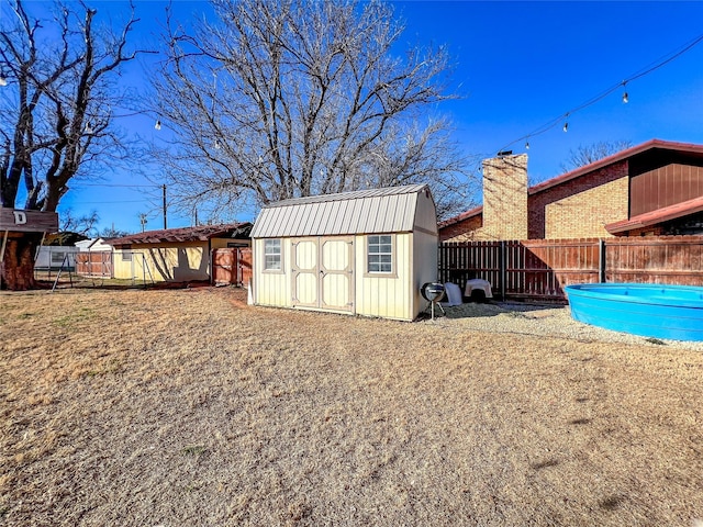 view of outbuilding with a swimming pool