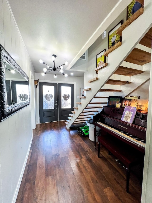 foyer entrance featuring ornamental molding, dark hardwood / wood-style flooring, and french doors