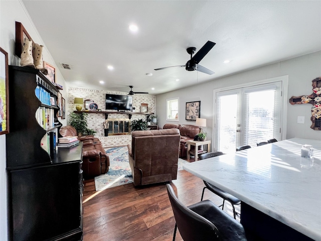 living room with dark hardwood / wood-style flooring, french doors, and ceiling fan