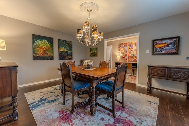 dining room featuring a notable chandelier and dark hardwood / wood-style flooring