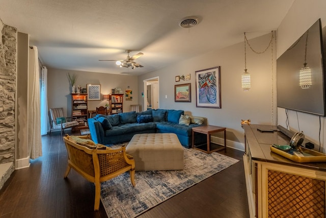 living room featuring dark hardwood / wood-style flooring and ceiling fan