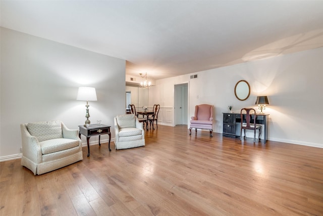 sitting room with light hardwood / wood-style flooring and a chandelier