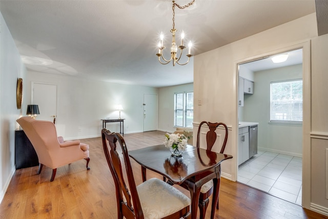 dining room with an inviting chandelier and light hardwood / wood-style flooring