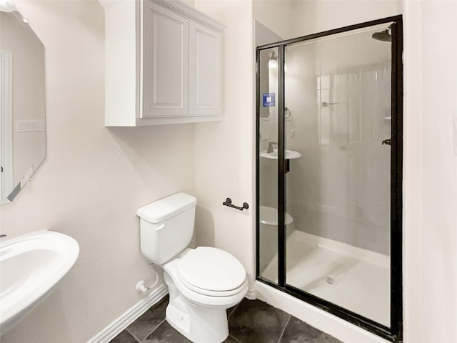 bathroom with sink, a shower with shower door, tile patterned floors, and toilet