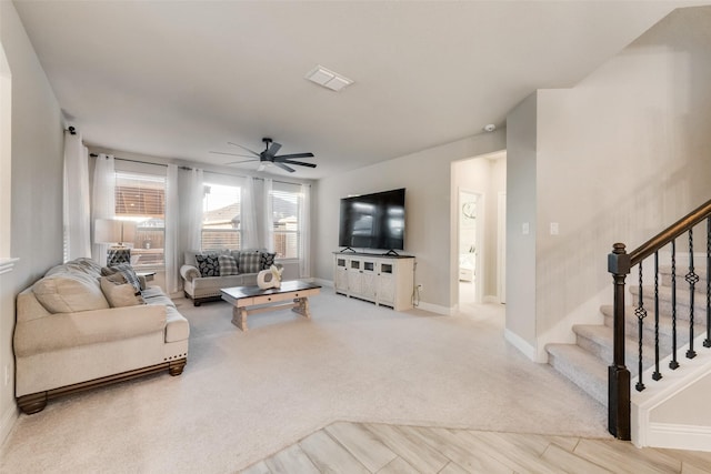 living room with light carpet and ceiling fan