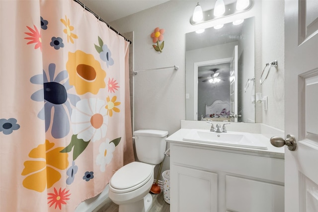 bathroom with a shower with curtain, vanity, and toilet