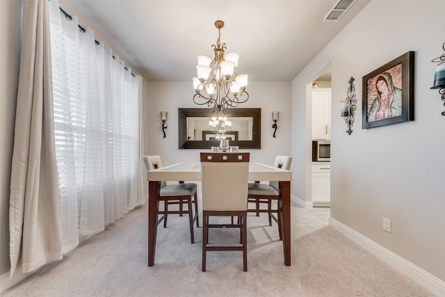 carpeted dining room with a notable chandelier