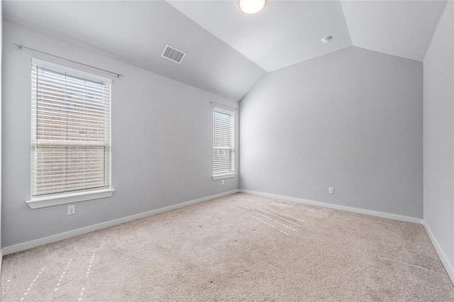 bonus room with vaulted ceiling and carpet