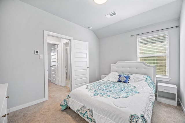 carpeted bedroom featuring vaulted ceiling