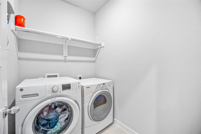 laundry room featuring independent washer and dryer and light tile patterned floors