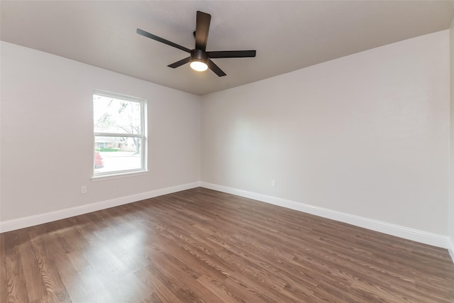 unfurnished room with dark hardwood / wood-style floors and ceiling fan