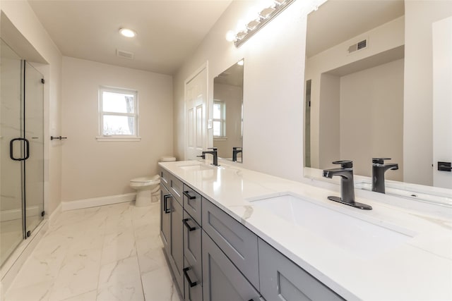 bathroom with vanity, toilet, and a shower with shower door