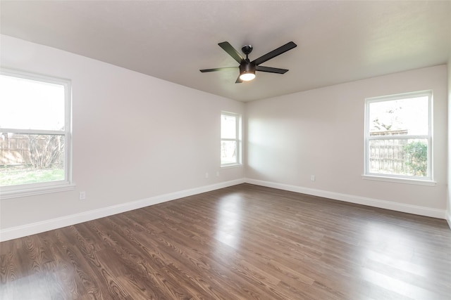 unfurnished room featuring dark wood-type flooring and ceiling fan