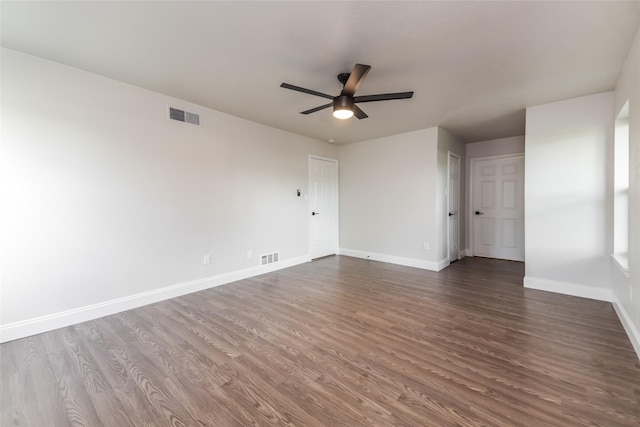 empty room with dark wood-type flooring and ceiling fan