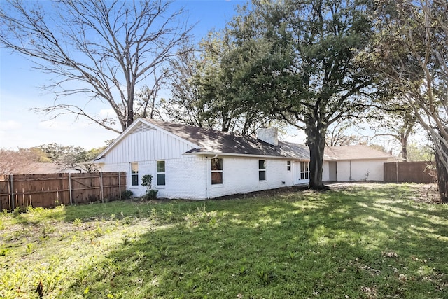 back of property featuring a lawn