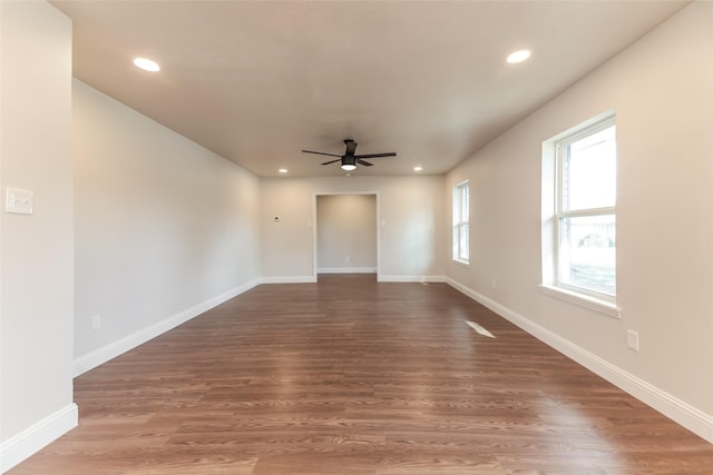 unfurnished room featuring dark hardwood / wood-style floors and ceiling fan