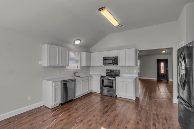 kitchen featuring stainless steel appliances, sink, dark wood-type flooring, and white cabinets