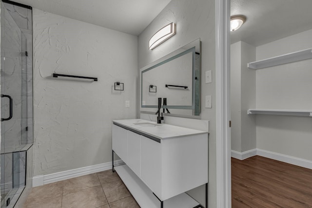 bathroom with vanity, tile patterned floors, and a shower with door