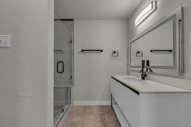 bathroom with vanity, tile patterned flooring, and a shower with door