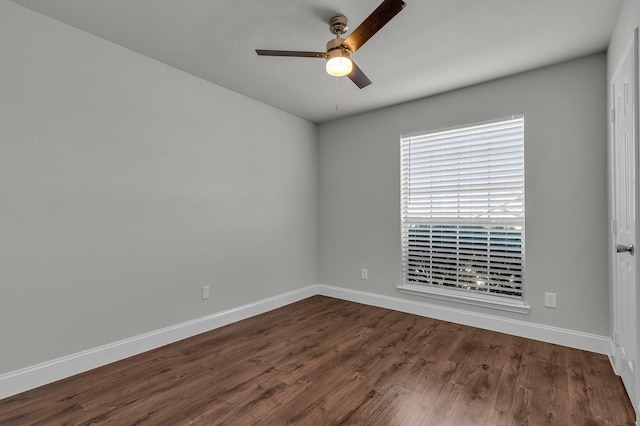 unfurnished room featuring dark wood-type flooring and ceiling fan