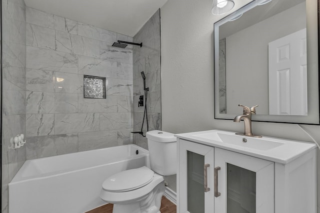 full bathroom with tiled shower / bath combo, vanity, and toilet