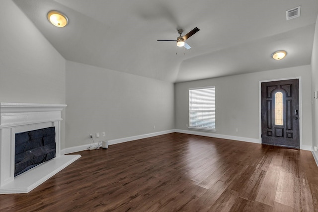 unfurnished living room with lofted ceiling, dark hardwood / wood-style floors, and ceiling fan