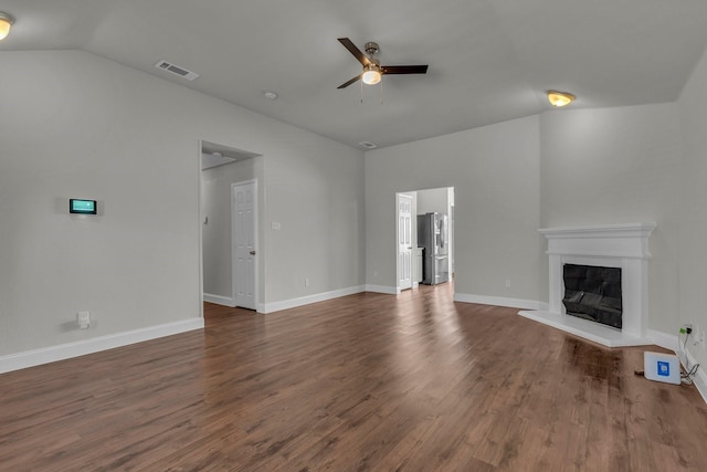 unfurnished living room with vaulted ceiling, dark wood-type flooring, and ceiling fan