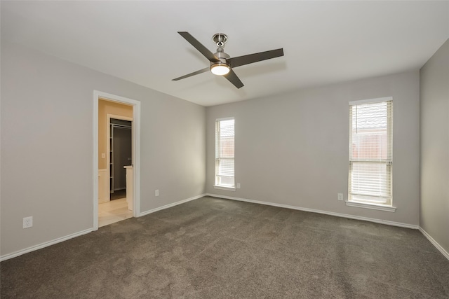 carpeted spare room featuring ceiling fan