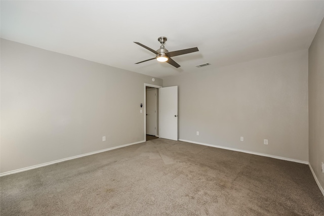 empty room featuring ceiling fan and carpet