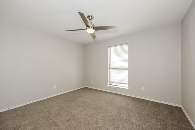 carpeted spare room featuring ceiling fan