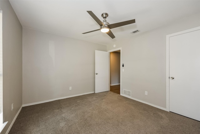 unfurnished room with ceiling fan and carpet flooring