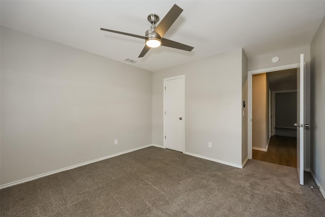 unfurnished bedroom with ceiling fan and dark colored carpet